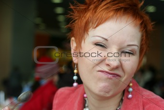 red haired woman is smiling in cafe