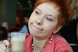 woman dreanking coffe in cafe and thoughtfully looks afar