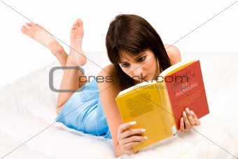 On my belly reading a book