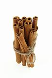 bunch of cinnamon sticks, tied by rope. soft focus.