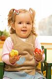 Little girl with easter egg and chicken