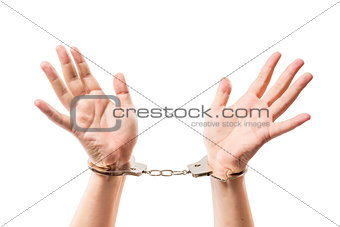 Male hands on a white background close-up in metal handcuffs