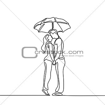 Romantic young couple kissing under umbrella
