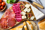 Antipasto. Olive board with salami, ham serrano, cheese, nuts and ciabatta bread