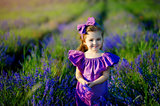 Little girl playing in nature at sunset. Selective focus and small depth of field.