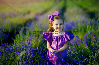 Little girl playing in nature at sunset. Selective focus and small depth of field.