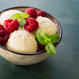 Homemade organic ice cream with fresh raspberries and mint.