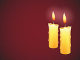 Two burning candles on red background