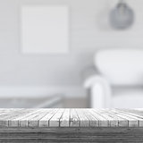 3D white wooden table looking out to a defocussed room interior