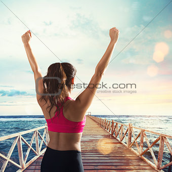 Stretching on a pier in front of sun