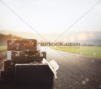 Luggage resting on asphalt