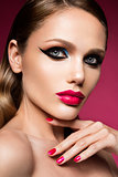 Beautiful young female face with bright fashion multicolored make-up