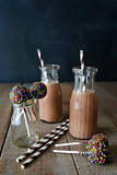 Chocolate milk with cake pops and straws