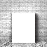 3D blank canvas leaning against a brick wall