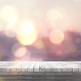 3D white wooden table looking out to a defocussed sunny landscap
