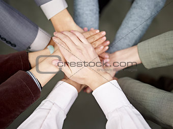 business team putting hands together
