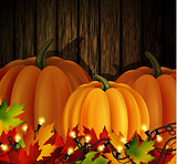 Autumn leaves and pumpkins on wooden texture