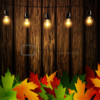 Wooden wall with autumn leaves