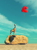 A giraffe standing on a large rock 