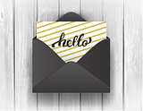 Black opened envelope with Hello Lettering on wooden background.