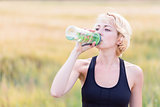 Fitness woman drinking water
