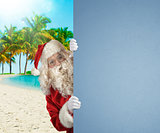 Santa Claus on a tropical beach with a blank space for your text