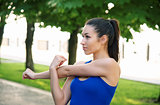 Young sporty woman doing shoulder exercises