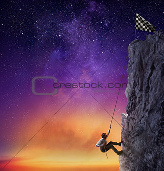 Businessman climb a mountain to get the flag. Achievement business goal and difficult career concept