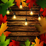 Wooden wall with autumn leaves frame