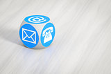 turquoise cube with signs for email phone and letter