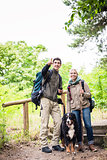 Hikers with dog in forest