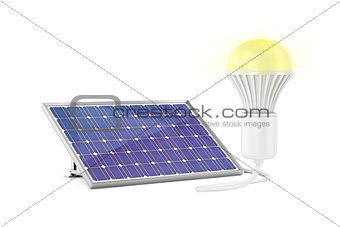 Solar panel and glowing light bulb
