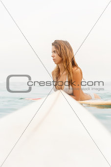One beautiful sporty girl surfing in the ocean.