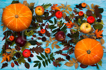 Thanksgiving greeting with fall leaves and pumpkin on blue backg