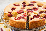 pie with plums and slice and cup with coffee