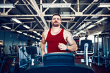 Muscle man running on treadmill.