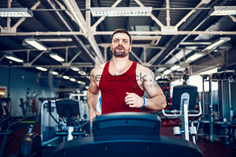 Muscle man running on treadmill.