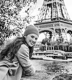 smiling young tourist woman on embankment in Paris, France