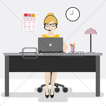 Female office worker with laptop and headphones