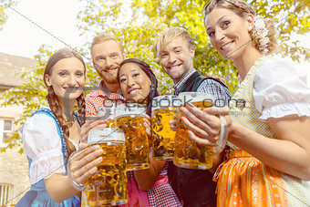 Friends in beer garden with beer glasses