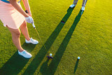 woman player ready to hit the ball into the hole at the end of a