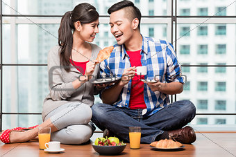 Young indonesian couple having breakfast