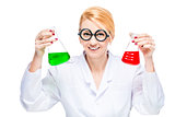 Blond chemist holds a test tube with a colored liquid on a white