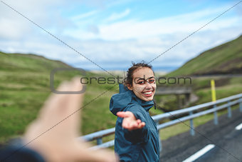 Cheerful traveler on background of road
