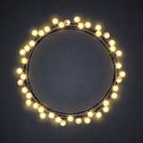 Warm colored vector light string Christmas wreath made of incandescent lamps. Vector illustration.