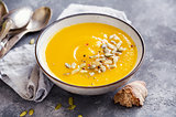 Bowl of squash soup with basil leaf