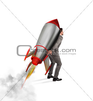 Determination and power businessman that holds a rocket isolated on white background