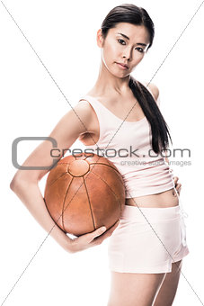 Young fit Asian woman holding brown medicine ball