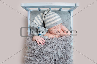 newborn baby sleeping on a bed