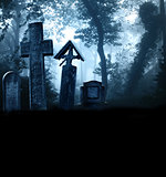 Medieval stone crosses and tombstones, cemetery in misty forest